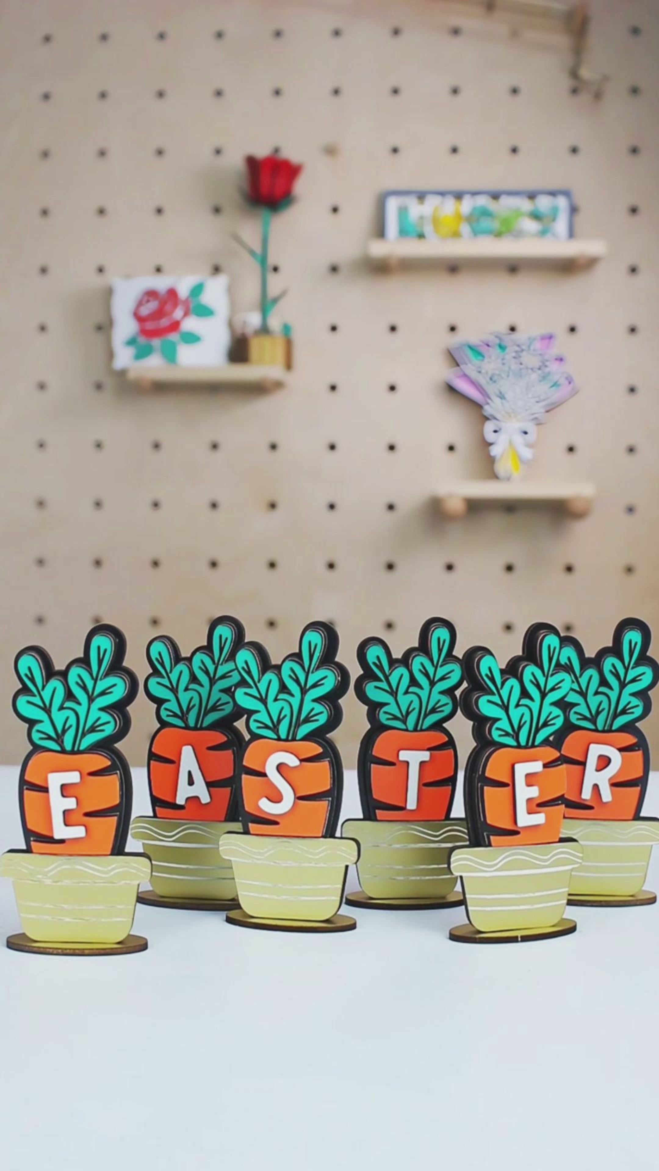 Laser cut carrot signs spelling "EASTER", designed as colorful tabletop decor for spring or Easter displays